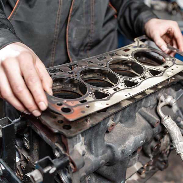 Service tech putting an Engine Head Gasket in