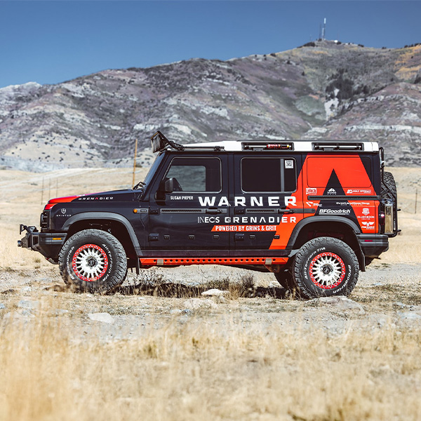 Side profile shot of the Ineos Grenadier parked on dirt